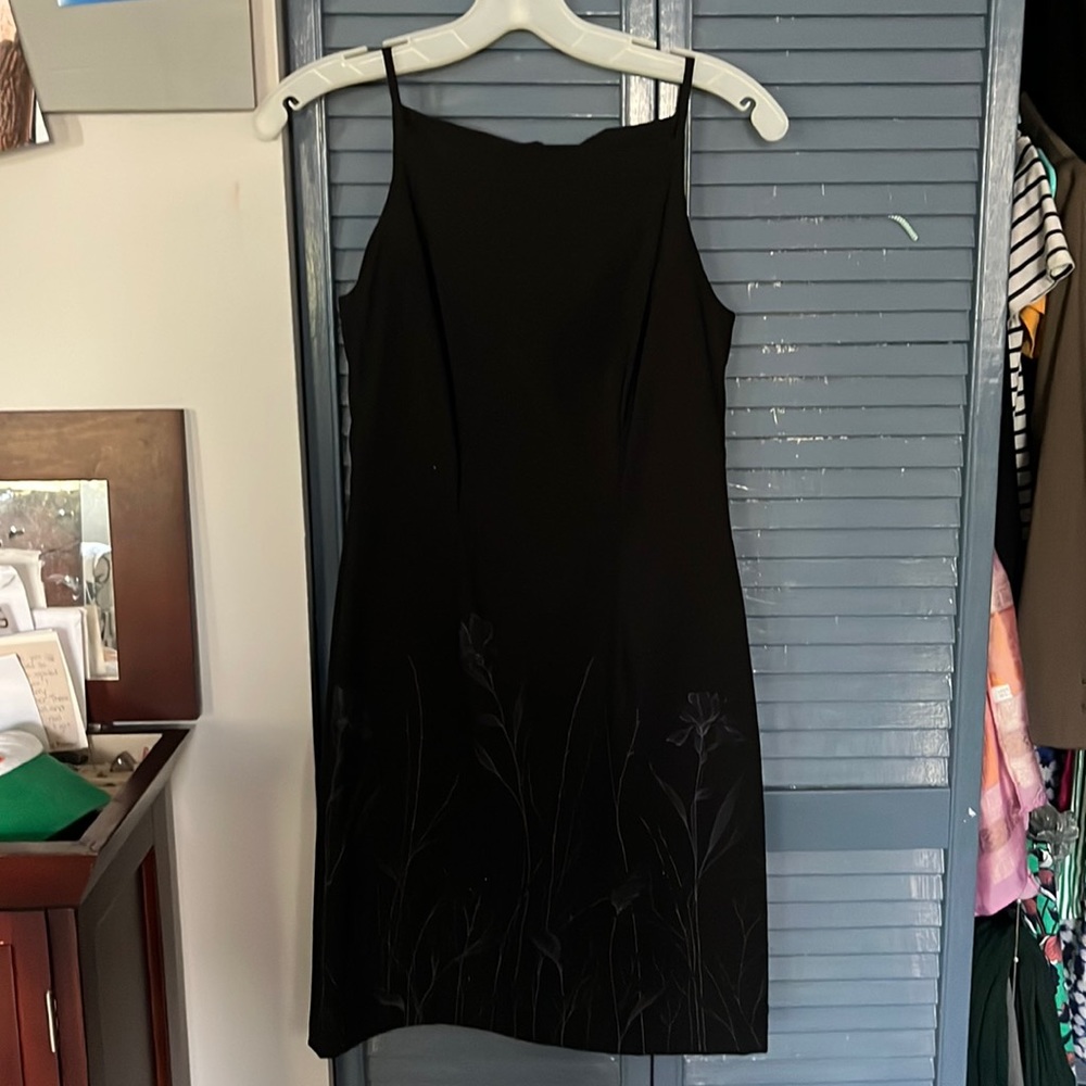 Black formal dress with beaded flower pattern on bottom of skirt